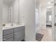 Bathroom with gray vanity, large mirror, and shower with curtain at 11844 W Nadine Way, Peoria, AZ 85383
