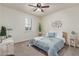 Cozy bedroom featuring soft carpet, a ceiling fan and a sunlit window at 11844 W Nadine Way, Peoria, AZ 85383
