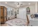 Cozy bedroom featuring a Murphy bed, a ceiling fan, plantation shutters, and light wood flooring at 11844 W Nadine Way, Peoria, AZ 85383