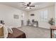 Cozy bedroom with a desk area, large window, and soft carpeting, perfect for work or relaxation at 11844 W Nadine Way, Peoria, AZ 85383