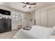 Bright bedroom with a ceiling fan, shutters, and ample storage, providing a serene and organized space at 11844 W Nadine Way, Peoria, AZ 85383
