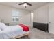 Bedroom featuring carpet, ceiling fan and a large window allowing natural light inside at 11844 W Nadine Way, Peoria, AZ 85383