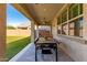 Inviting covered patio featuring an outdoor dining area, ceiling fan, and views of the expansive backyard at 11844 W Nadine Way, Peoria, AZ 85383