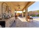 Relaxing covered patio with bar, grill, and seating area; perfect for entertaining guests in the spacious backyard at 11844 W Nadine Way, Peoria, AZ 85383