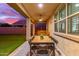 Outdoor covered patio with ceiling fan, dining area and comfortable seating, perfect for enjoying outdoor living at 11844 W Nadine Way, Peoria, AZ 85383