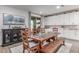 Rustic dining area featuring a wooden table, bench seating, and ample natural light at 11844 W Nadine Way, Peoria, AZ 85383