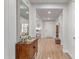 Welcoming home entryway with wood floors, a large mirror, console table and decor at 11844 W Nadine Way, Peoria, AZ 85383