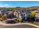 Beautiful two-story home with lush landscaping and mature trees, set against a backdrop of scenic mountains at 11844 W Nadine Way, Peoria, AZ 85383