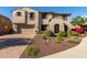 Charming two-story home featuring a well-manicured front yard and a two car garage on a sunny day at 11844 W Nadine Way, Peoria, AZ 85383