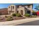 Beautiful two-story home featuring an arched entryway, desert landscaping and a two car garage on a sunny day at 11844 W Nadine Way, Peoria, AZ 85383