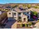 Desirable two-story home with a brick driveway, a well-maintained yard, and solar panels on the roof at 11844 W Nadine Way, Peoria, AZ 85383