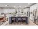 Kitchen featuring a spacious island with seating, white cabinets, and stainless steel appliances at 11844 W Nadine Way, Peoria, AZ 85383