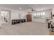 Open living room features large windows, plush carpeting, and custom built-ins for a cozy atmosphere at 11844 W Nadine Way, Peoria, AZ 85383