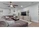 Comfortable living room with a large sectional sofa, ceiling fan, and entertainment center at 11844 W Nadine Way, Peoria, AZ 85383