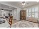 Bright living room with an area rug, ceiling fan, plantation shutters, and light wood flooring at 11844 W Nadine Way, Peoria, AZ 85383
