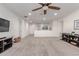 Expansive living room with neutral tones, a ceiling fan, and plentiful natural light for comfort and style at 11844 W Nadine Way, Peoria, AZ 85383