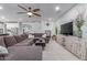 Open concept living room with a large sectional sofa, fireplace, and easy access to the kitchen at 11844 W Nadine Way, Peoria, AZ 85383