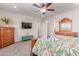 Main bedroom with a large TV, dresser, and patterned bedding at 11844 W Nadine Way, Peoria, AZ 85383