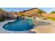 Resort-style pool featuring a rock waterfall, spa, and travertine tile decking perfect for outdoor relaxation and entertainment at 11844 W Nadine Way, Peoria, AZ 85383