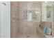 Luxurious walk-in shower with decorative tile, a built-in bench, and a rainfall shower head at 11844 W Nadine Way, Peoria, AZ 85383