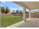 Back patio overlooking the expansive green backyard, enclosed by a block wall fence at 1237 W Agrarian Hills Dr, San Tan Valley, AZ 85143
