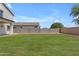 Expansive backyard showcasing a well-maintained lawn and block wall for privacy at 1237 W Agrarian Hills Dr, San Tan Valley, AZ 85143