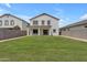 Large backyard featuring a covered patio and lush green grass, perfect for entertaining at 1237 W Agrarian Hills Dr, San Tan Valley, AZ 85143