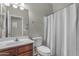 Bathroom featuring a vanity with wood cabinetry, toilet, and shower with curtain at 1237 W Agrarian Hills Dr, San Tan Valley, AZ 85143
