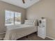 Cozy bedroom with neutral tones, plush carpet, and window overlooking the neighborhood at 1237 W Agrarian Hills Dr, San Tan Valley, AZ 85143