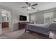 Spacious bedroom with carpet, a ceiling fan, TV, and plenty of natural light from the large windows at 1237 W Agrarian Hills Dr, San Tan Valley, AZ 85143