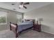 Comfortable bedroom featuring a ceiling fan, large window, and carpet flooring with a neutral color palette at 1237 W Agrarian Hills Dr, San Tan Valley, AZ 85143