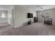 Spacious bonus room with plush carpet, ceiling fan, and a TV for entertainment at 1237 W Agrarian Hills Dr, San Tan Valley, AZ 85143