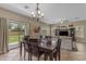 Open concept dining room and living room combo with sliding door access to outdoor space at 1237 W Agrarian Hills Dr, San Tan Valley, AZ 85143