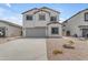 Two-story home with a two-car garage, neutral paint, rock landscaping and concrete driveway at 1237 W Agrarian Hills Dr, San Tan Valley, AZ 85143