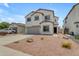 Two-story home with a two-car garage, neutral paint, rock landscaping and concrete driveway at 1237 W Agrarian Hills Dr, San Tan Valley, AZ 85143