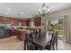 Dining area with a view into the kitchen featuring stainless steel appliances and granite countertops at 1237 W Agrarian Hills Dr, San Tan Valley, AZ 85143