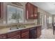 Modern kitchen featuring stainless steel sink, granite countertops and dark wood cabinets at 1237 W Agrarian Hills Dr, San Tan Valley, AZ 85143