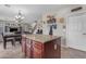 Stylish kitchen island with granite countertop in open floor plan with dining and Gathering areas at 1237 W Agrarian Hills Dr, San Tan Valley, AZ 85143