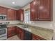 Kitchen showcasing granite countertops, a window, and dark wood cabinets at 1237 W Agrarian Hills Dr, San Tan Valley, AZ 85143
