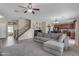 Inviting open-concept living room featuring staircase, ceiling fan, and carpeted floors at 1237 W Agrarian Hills Dr, San Tan Valley, AZ 85143