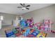 Playroom filled with toys, alphabet rug, dollhouse and princess tent under a ceiling fan at 1237 W Agrarian Hills Dr, San Tan Valley, AZ 85143