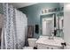 Cozy bathroom featuring a shower with patterned curtain and a well-lit vanity area at 125 S 56Th St # 36, Mesa, AZ 85206