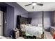 Bedroom with canopy bed frame, a ceiling fan, and a window overlooking the backyard at 125 S 56Th St # 36, Mesa, AZ 85206