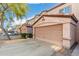 Row of attached garages for townhomes featuring a tile roof and a well-kept landscape at 125 S 56Th St # 36, Mesa, AZ 85206
