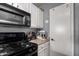 The kitchen features white cabinets and black appliances at 125 S 56Th St # 36, Mesa, AZ 85206