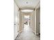 Inviting condo hallway with white walls, tiled flooring, and living room view at 140 E Rio Salado Pkwy # 512, Tempe, AZ 85281