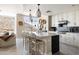 Modern kitchen features white cabinets, an island with seating, and stainless steel appliances, bathed in natural light at 140 E Rio Salado Pkwy # 512, Tempe, AZ 85281