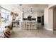 Open-concept kitchen with white cabinets, an island with seating, stainless steel appliances, and designer lighting fixtures at 140 E Rio Salado Pkwy # 512, Tempe, AZ 85281