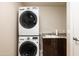 Laundry room with stacked washer and dryer units and utility sink at 140 E Rio Salado Pkwy # 512, Tempe, AZ 85281