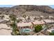 An aerial view shows the neighborhood homes and a mountain in the background on a sunny day at 14033 S 31St St, Phoenix, AZ 85048